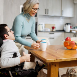 caregiver serving the child on a wheelchair